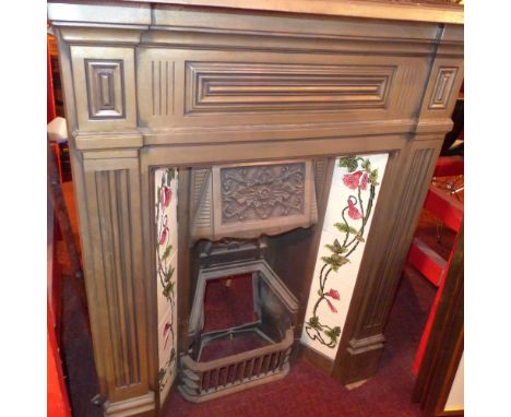 A cast iron fireplace with inset Art Nouveau style tiles