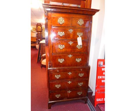 A Georgian style walnut and crossbanded chest on chest fitted arrangement of eight drawers and brushing slide with brass hand