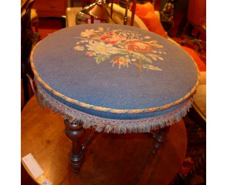 A Victorian walnut stool with tapestry seat and raised on stretchered supports