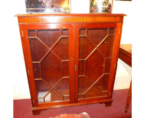 A mahogany bookcase fitted pair of astragal glazed panel doors on bracket feet