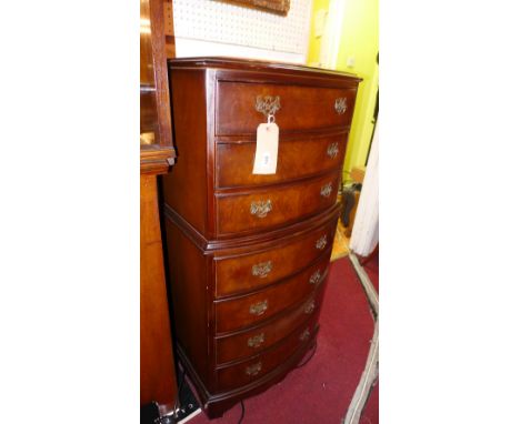 A walnut bow fronted tall chest fitted seven drawers raised on bracket feet 