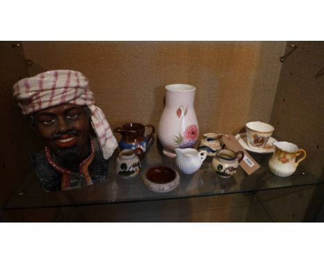 A collection of items including motto ware, a silver jubilee cup and saucer, a ceramic portrait bust of a black man and other