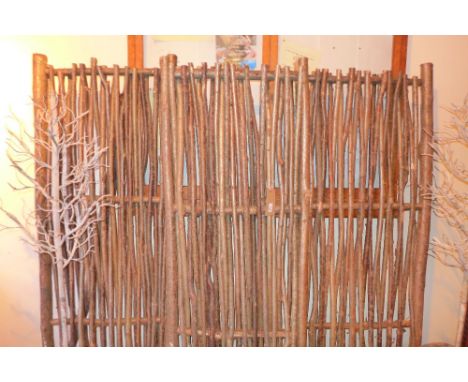 A set of rustic gate panels constructed from branches 