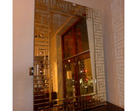 An Art Deco style wall mirror with rectangular plate and marginal border