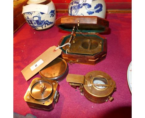 A brass sundial compass and three others 
