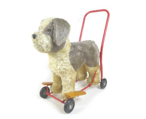 A mid-20th century Lines Brothers push-along baby walker, in the form of a dog, light brown mohair with beaded eyes, black se
