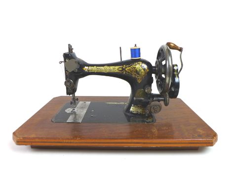 A Singer sewing machine, serial 14691646, in wooden case, together with a Victorian wheel barometer, the silvered dial signed