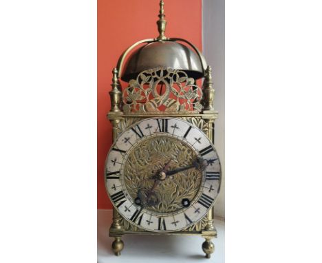 A brass bell-striking lantern clock, having dolphin cresting, the 6.25" dial with engraved tulips within the silvered chapter