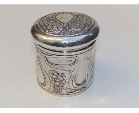 An art nouveau embossed silver dressing table jar of cylindrical form, the cover decorated with a pair of peacocks - HM, Birm