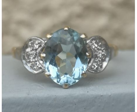 An aquamarine &amp; diamond set 18ct gold ring.  Finger size N/O.