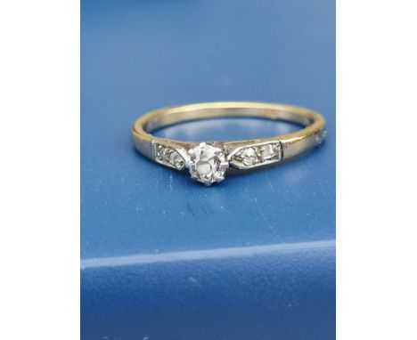 A small old cut diamond solitaire ring, diamonds to shoulders, on 18ct gold shank.  Finger size P.