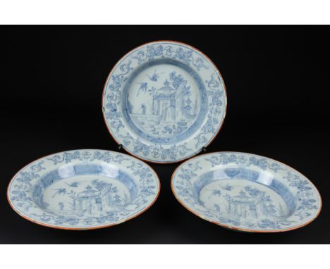 Three English Delftware soup plates, probably Liverpool the shallow bowl with everted rim decorated with pencilled design of 