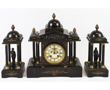A black slate mantel clock with gilt decoration, the clock face flanked by three pillars surmounted by cupola with pine cone 
