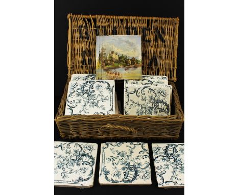 Eleven blue &amp; white printed tiles, with 'C' scroll and rose decoration; a tile painted in colours with a view of a ruined