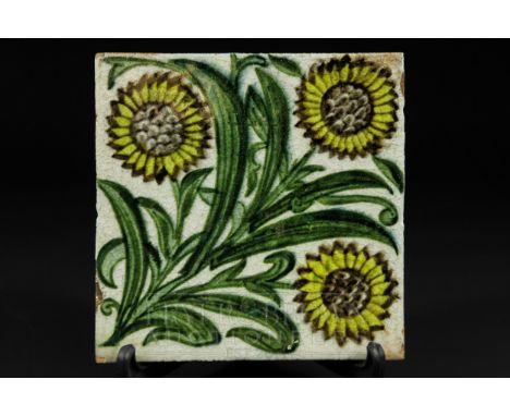 A William de Morgan Bedford Park tile, the pale grey ground decorated with three leafy sunflowers to corners, 15.5cm square a