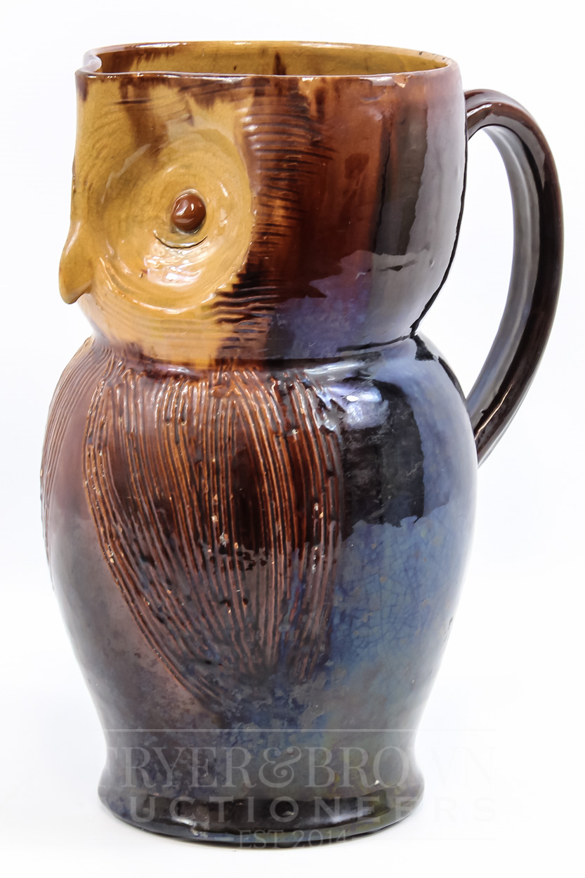 A Farnham Pottery ewer in the form of an owl, by Harry Corrigan, brown
