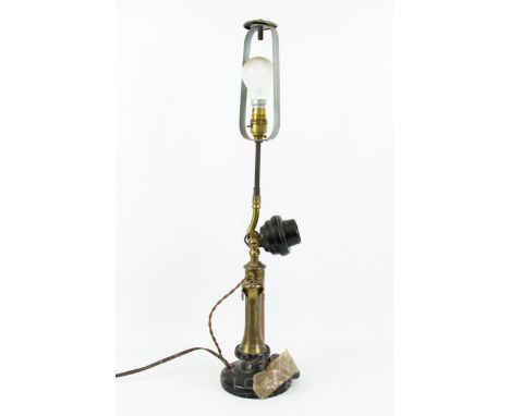 A vintage brass and copper upright telephone, converted to a lamp