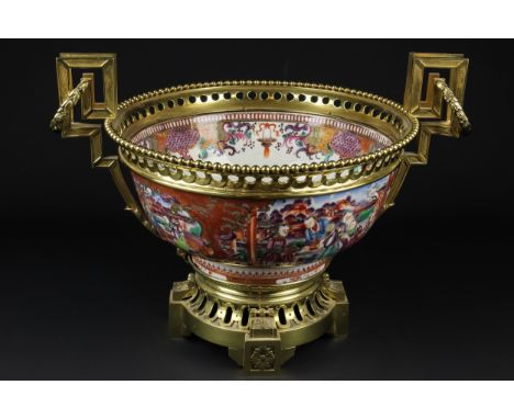 A Chinese porcelain punch bowl, famille rose mandarin palette, painted with figures within 'C' scroll mirror form cartouches,
