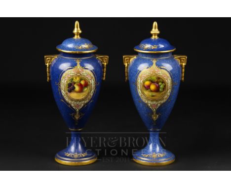 A pair of Royal Worcester vases &amp; covers, signed E. Townsend, powder blue ground with reserves of fruit, shape no. 2713, 