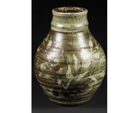 An Art Pottery vase in the style of Bernard Leach, decorated with leafy fronds in tones of green/grey and brown, indistinct p