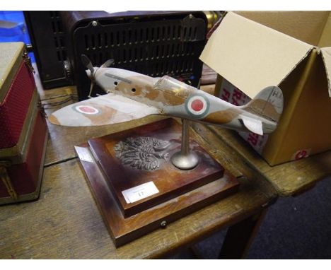 An unusual World War II model of a spitfire, painted wood, mounted on a stand applied with a Polish Eagle crest and bearing a