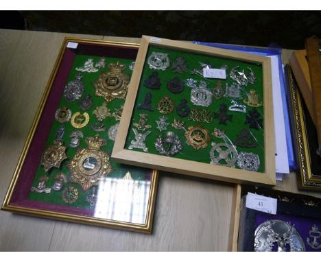 A collection of British military cap, shoulder and cross-belt badges, mounted in two frames, including the Lowland Regiment, 