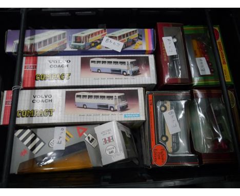 Crate containing a collection of boxed model vehicles including Volvo coach