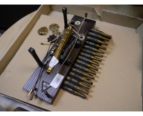 Brass model cannon and a group of spent cartridges together with RAF cap badges etc