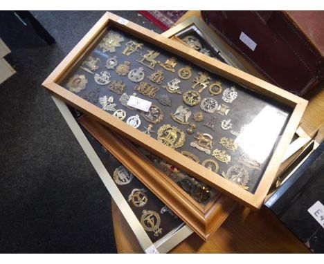 A collection of British military cap, shoulder and cross-belt badges, mounted in three frames, including Royal Scots Greys, N