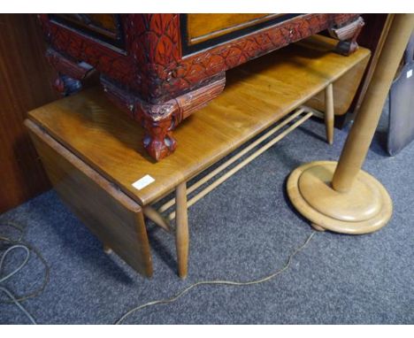 Mid 20th century Ercol elm twin drop leaf two tier coffee table raised on turned supports