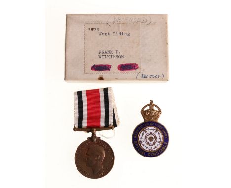 Special Constable long service medal to FRANK D WILKINSON in issue box and a West Riding of Yorkshire cap badge (2)