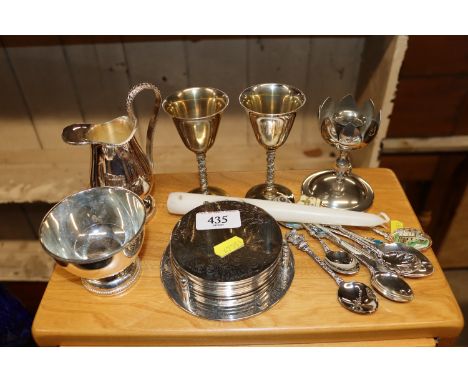 A set of plated table coasters; a plated sugar bowl and cream jug; candlestick etc. 