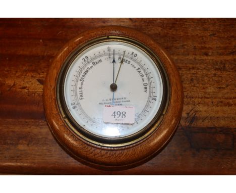 An oak cased aneroid barometer by J.H. Steward of London