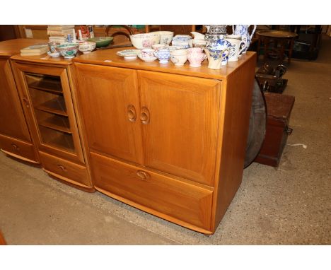 A blond Ercol television cabinet 