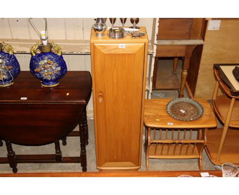 A blond Ercol narrow cupboard