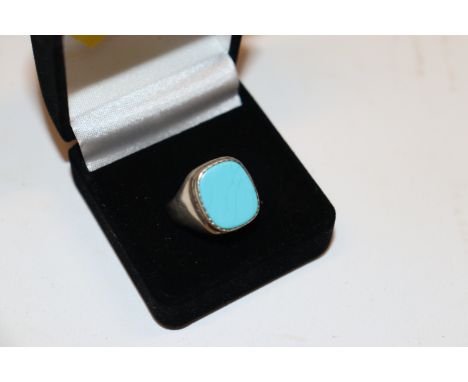 A silver and turquoise set signet ring 