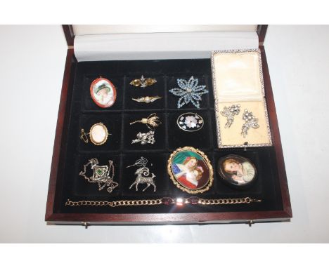 A box containing vintage and other brooches to include portrait brooches, cameo brooch, and a yellow metal bracelet set with 