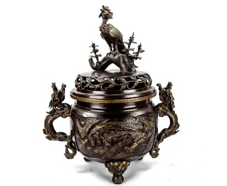 A large Chinese patinated bronze incense burner, with exotic bird finial, parcel gilt relief cast panels and dragon handles, 