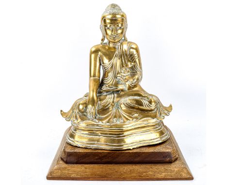 A Chinese polished bronze seated Buddha on wood plinth, height 38cm 