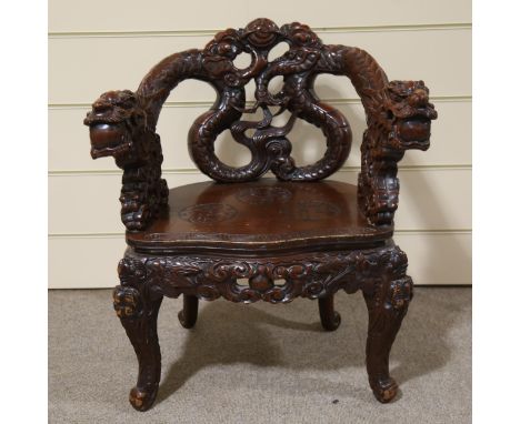 A 19th century Japanese carved wood dragon chair, heavily carved dragon decorated back, relief carved text to the seat, raise