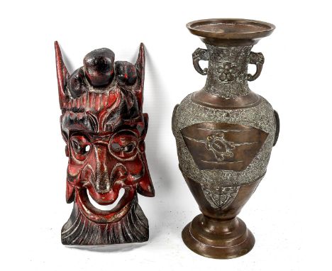 A Chinese relief moulded bronze vase, height 23cm, and a small carved wood wall mask, length 23cm (2) 