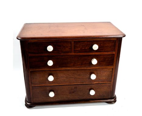A Victorian mahogany apprentice chest of drawers, with ceramic handles and bun feet, width 38cm, height 30cmGood original con