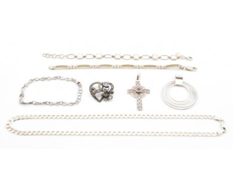 A collection of vintage silver jewellery. The lot to include three bracelets, a crucifix pendant set with a round cut purple 