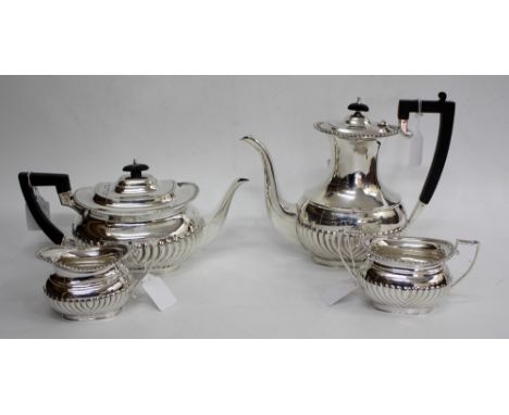 A MAPPIN & WEBB FOUR PIECE TEA AND COFFEE SET consisting of a tea pot, coffee pot, cream jug and sucrier, all with trophy han