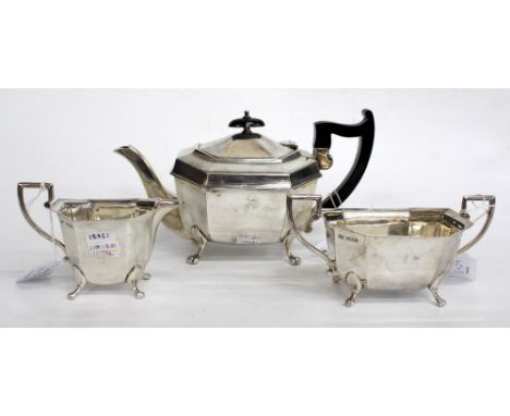 A THREE PIECE SHEFFIELD SILVER TEASET consisting of a teapot, sucrier and cream jug standing on four splayed pad feet (3)