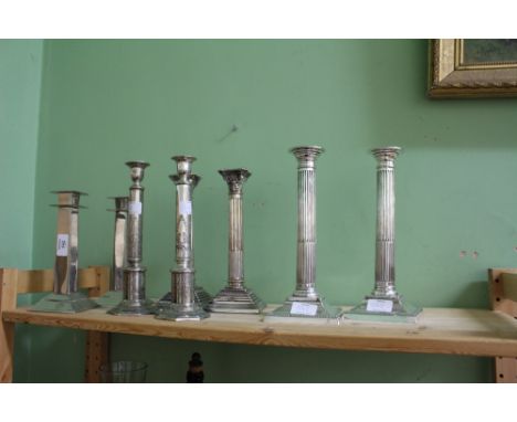 A PAIR OF SILVER PLATED CANDLESTICKS of Corinthian column form, each 25cm in height, a pair of Art Deco style silver plated c