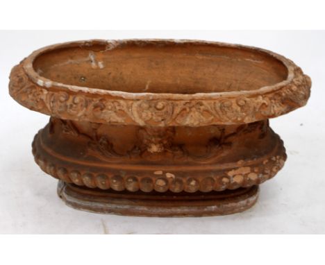 A 19TH / 20TH CENTURY TERRACOTTA PLANTER with lion mask acanthus foliate decoration on stepped base, 22cm high