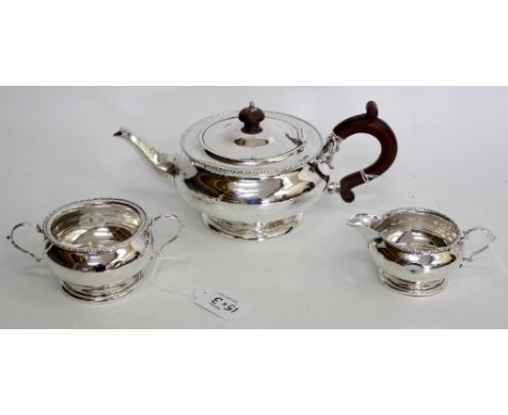 A MAPLE & CO LONDON SILVER TEA SET consisting of a tea pot, cream jug and sucrier with twin handles (3)