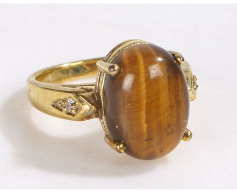 Yellow metal and tigers eye ring, the head set with a claw mounted oval tigers eye stone, ring size R weight 7.3 grams&nbsp;