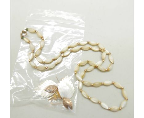 A 9ct gold bead and mother of pearl necklace, the clasp marked 9ct, and two pairs of earrings 